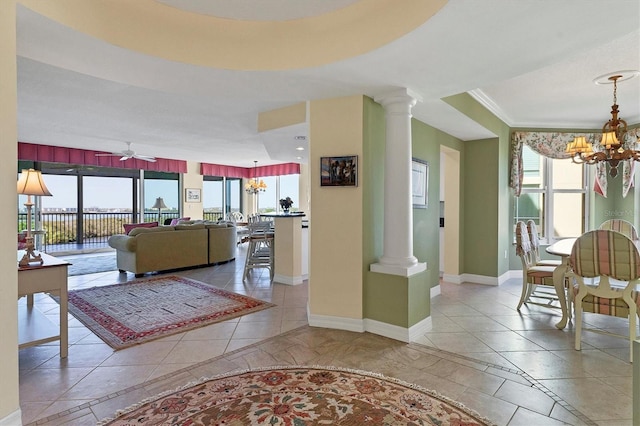 interior space with ornate columns, ceiling fan with notable chandelier, and a wealth of natural light