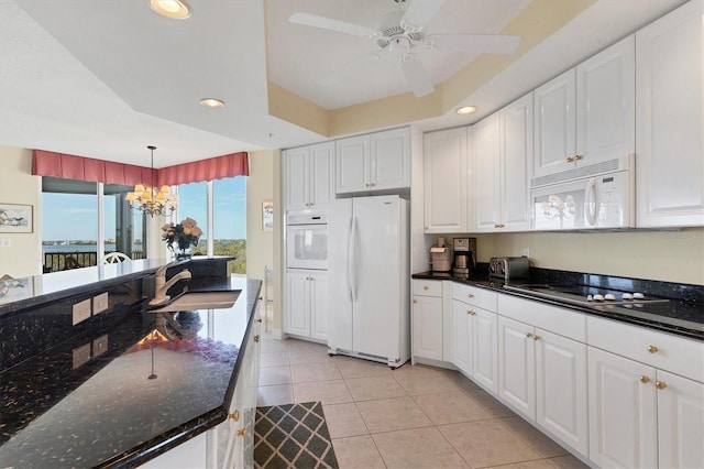 kitchen with white cabinetry, white appliances, sink, and hanging light fixtures