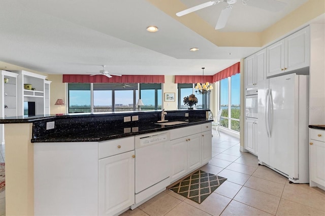 kitchen featuring white cabinetry, white appliances, decorative light fixtures, and sink