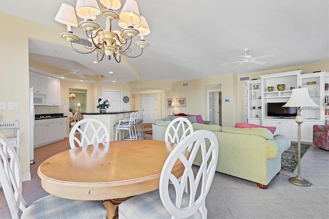 tiled dining room featuring ceiling fan with notable chandelier