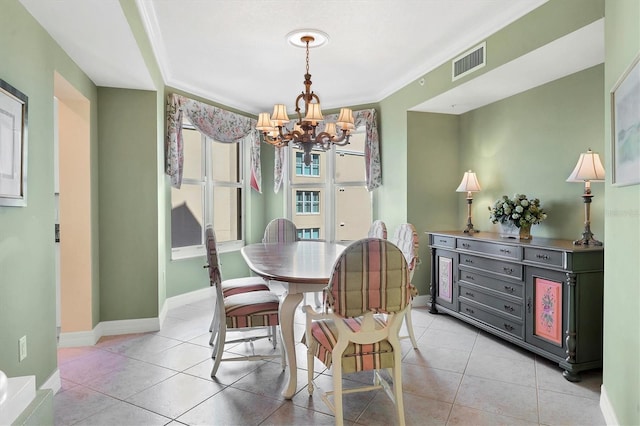 dining space with light tile patterned floors, ornamental molding, and a chandelier