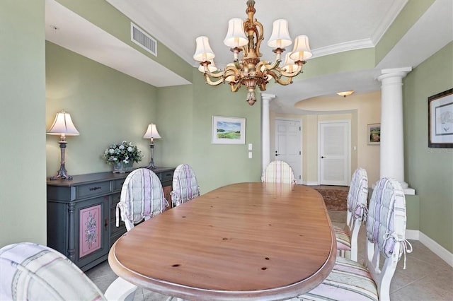 tiled dining room featuring a notable chandelier, crown molding, and ornate columns