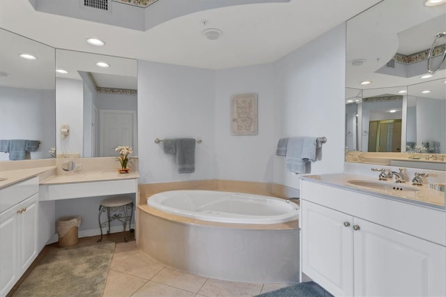 bathroom with tile patterned flooring, a bath, and vanity