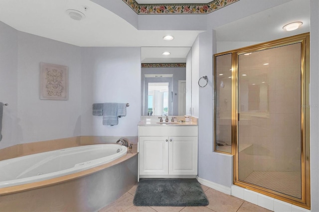 bathroom with tile patterned flooring, vanity, and independent shower and bath