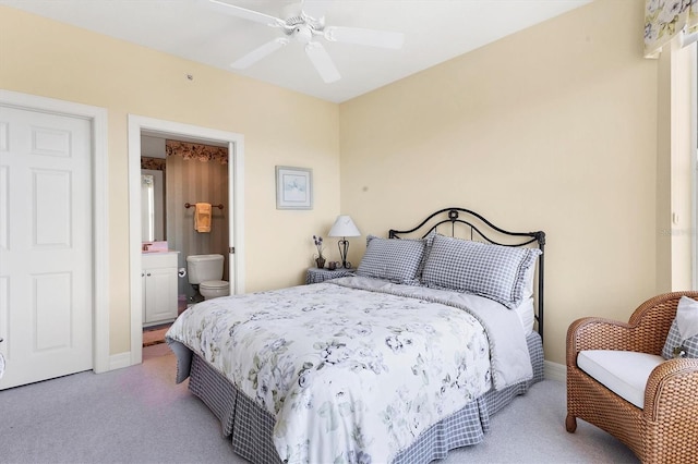 carpeted bedroom with ceiling fan and ensuite bathroom