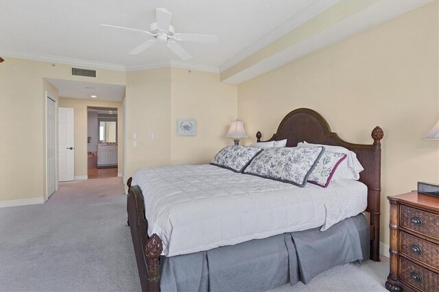 carpeted bedroom featuring crown molding, connected bathroom, and ceiling fan