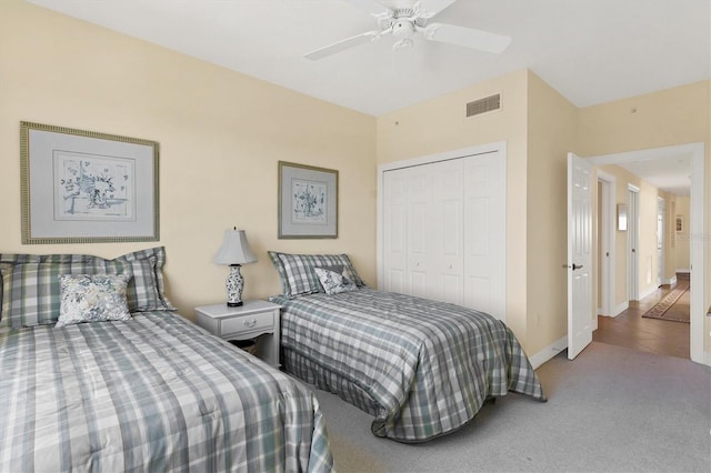 carpeted bedroom with ceiling fan and a closet