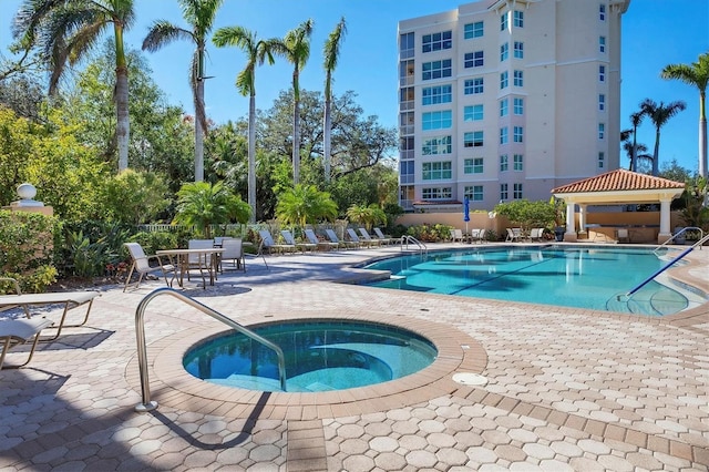 view of pool with a gazebo, a hot tub, and a patio