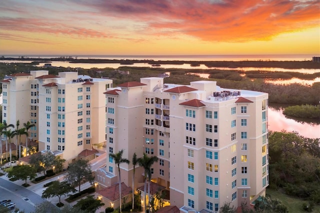 outdoor building at dusk featuring a water view