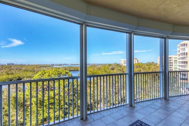 unfurnished sunroom featuring a water view