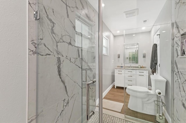 bathroom featuring vanity, toilet, and walk in shower