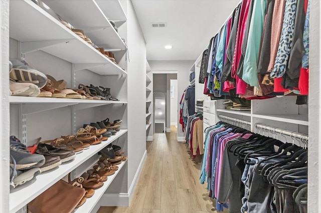 spacious closet featuring light hardwood / wood-style floors