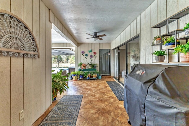 sunroom / solarium featuring ceiling fan