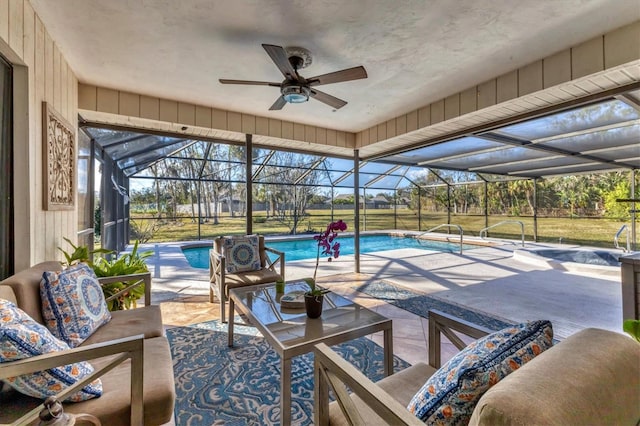 view of pool with a patio, an outdoor hangout area, ceiling fan, and glass enclosure