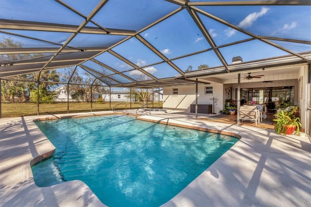 view of pool with a lanai, ceiling fan, and a patio area