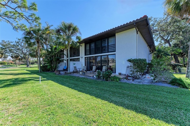 rear view of property with a yard