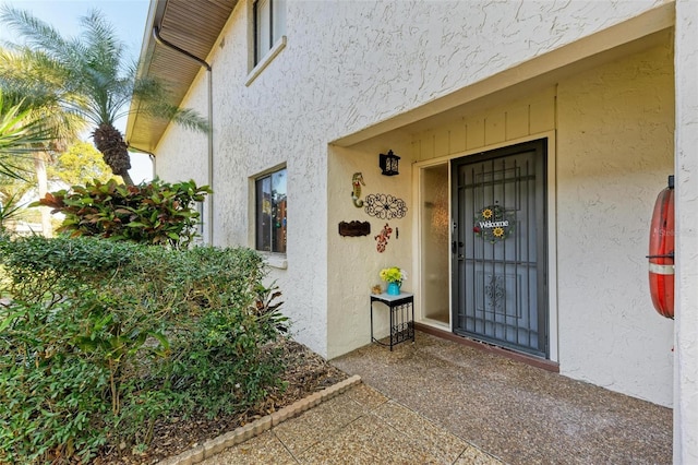 doorway to property with stucco siding