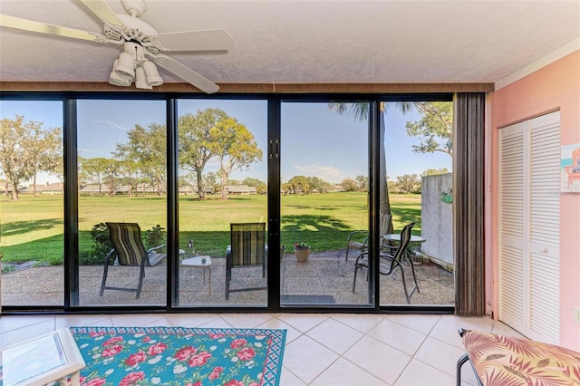 entryway featuring tile patterned floors and ceiling fan