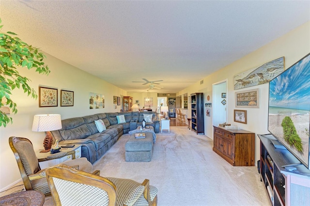 carpeted living room with ceiling fan and a textured ceiling