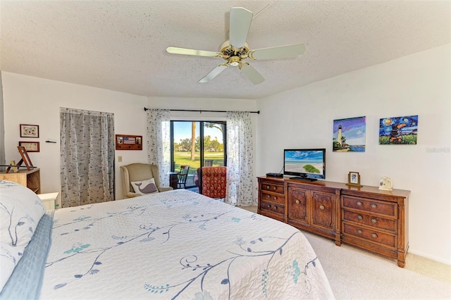 bedroom featuring ceiling fan, light carpet, access to outside, and a textured ceiling