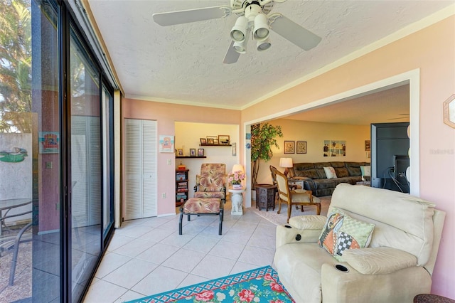 living room with a textured ceiling, light tile patterned flooring, and a ceiling fan