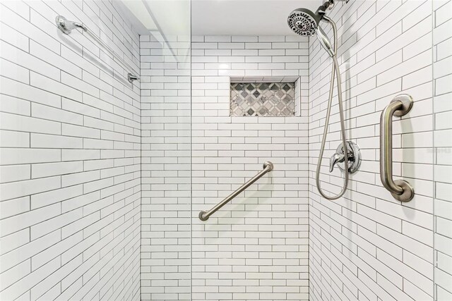 bathroom with tiled shower