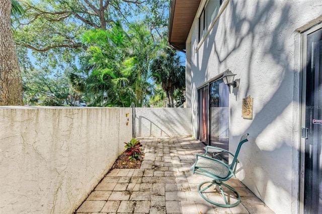 view of patio with a gate and fence