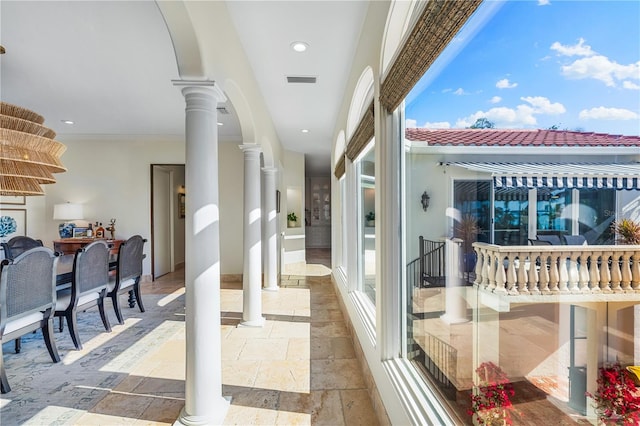 interior space featuring decorative columns and ornamental molding