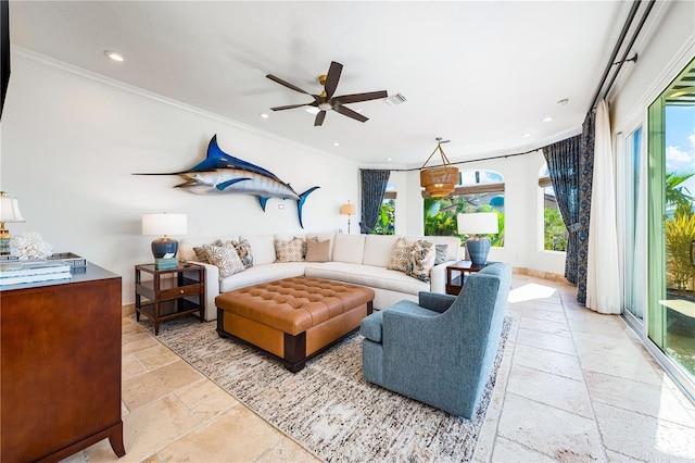 living room with ornamental molding, plenty of natural light, and ceiling fan