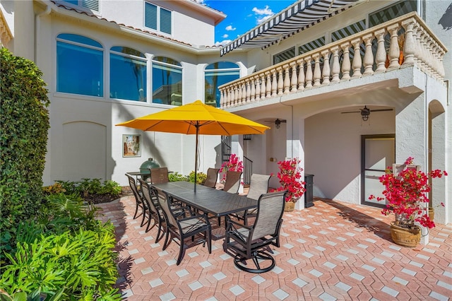 view of patio with a balcony and ceiling fan