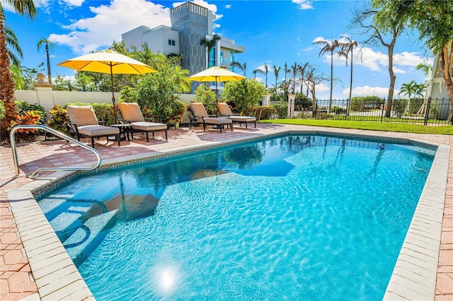 view of pool featuring a patio area, fence, and a fenced in pool