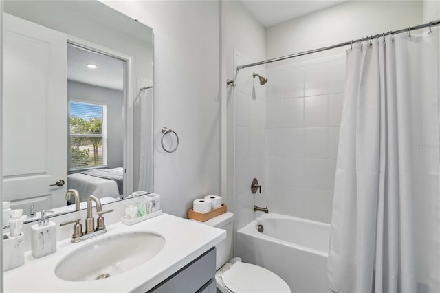 full bathroom featuring vanity, shower / bath combination with curtain, and toilet