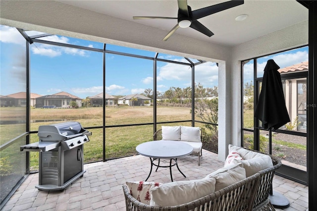 sunroom with plenty of natural light and ceiling fan