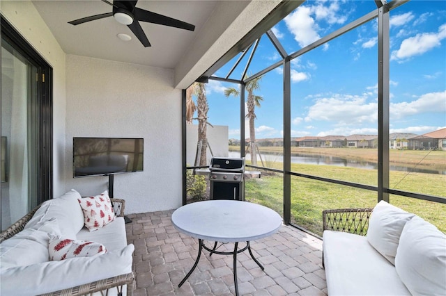 sunroom / solarium featuring ceiling fan