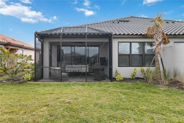 back of property featuring a patio, a yard, and glass enclosure