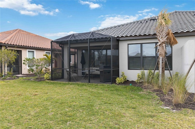 rear view of house with a yard, a lanai, and a patio