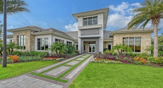 rear view of property featuring a yard