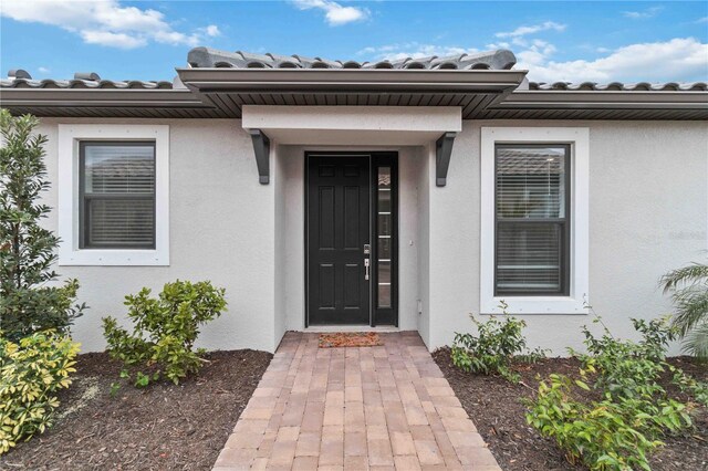 3016 Formia Ct, Bradenton, FL 34211 - doorway to property with stucco siding and a tile roof