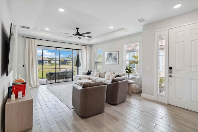3016 Formia Ct, Bradenton, FL 34211 - living area featuring a tray ceiling, healthy amount of natural light, a ceiling fan, light wood-type flooring, and recessed lighting