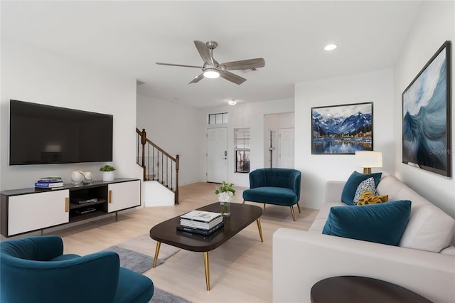 living room featuring ceiling fan and light hardwood / wood-style floors