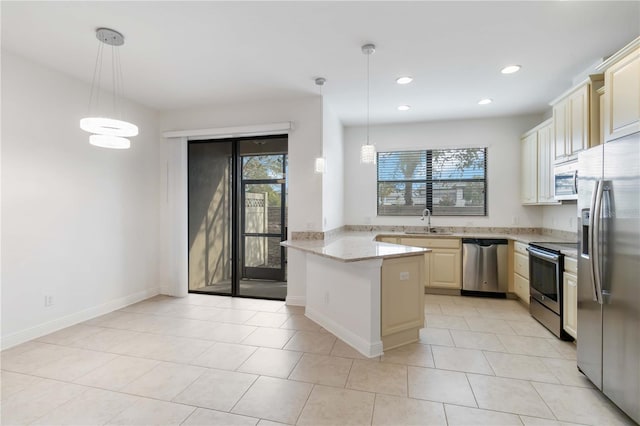 kitchen featuring sink, stainless steel appliances, light stone counters, decorative light fixtures, and kitchen peninsula