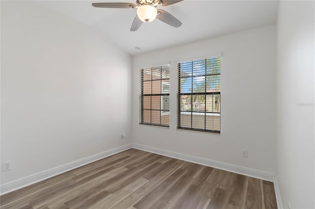 spare room featuring ceiling fan, lofted ceiling, and hardwood / wood-style floors