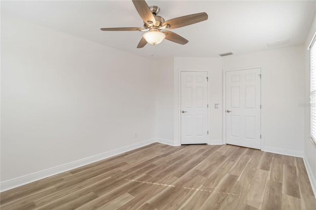 unfurnished bedroom with ceiling fan and light wood-type flooring