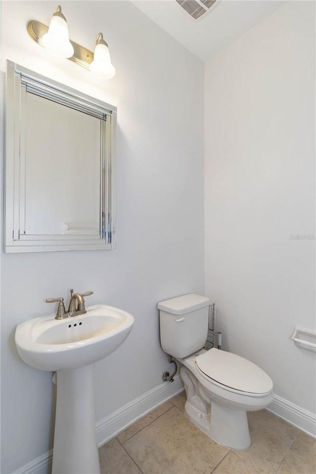 bathroom featuring tile patterned flooring and toilet