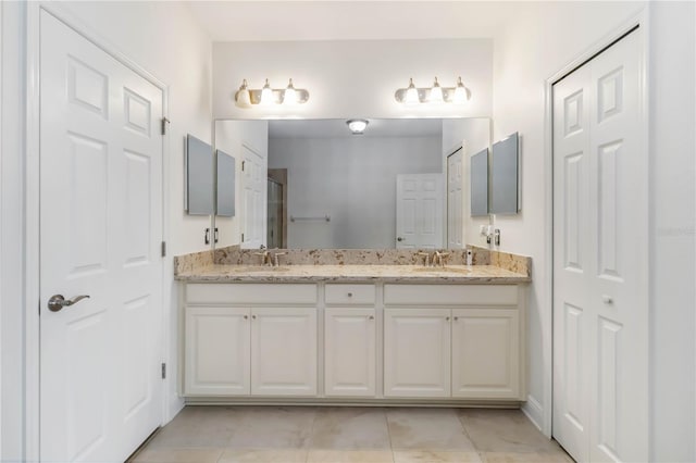 bathroom with tile patterned floors and vanity