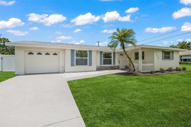 single story home with a garage and a front lawn