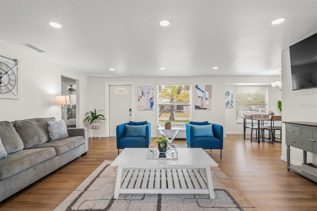 living room featuring a chandelier and hardwood / wood-style floors