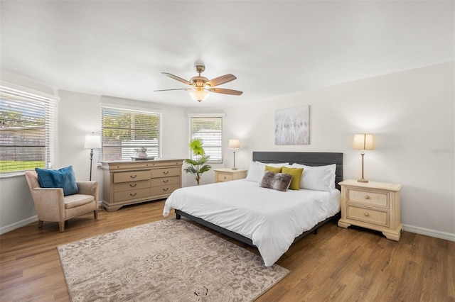 bedroom with ceiling fan and light wood-type flooring