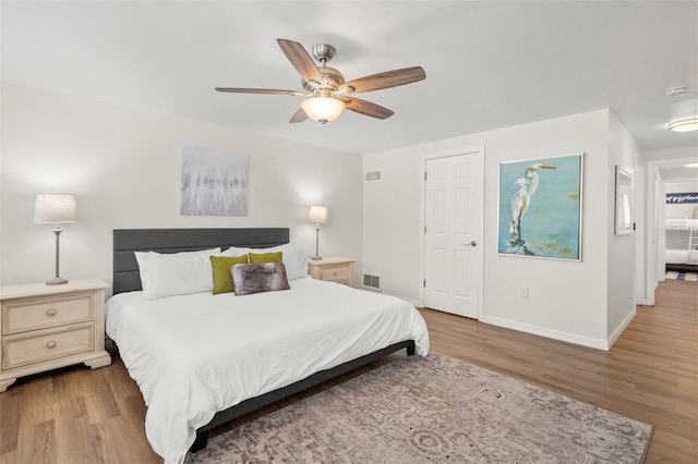 bedroom with ceiling fan and light hardwood / wood-style floors