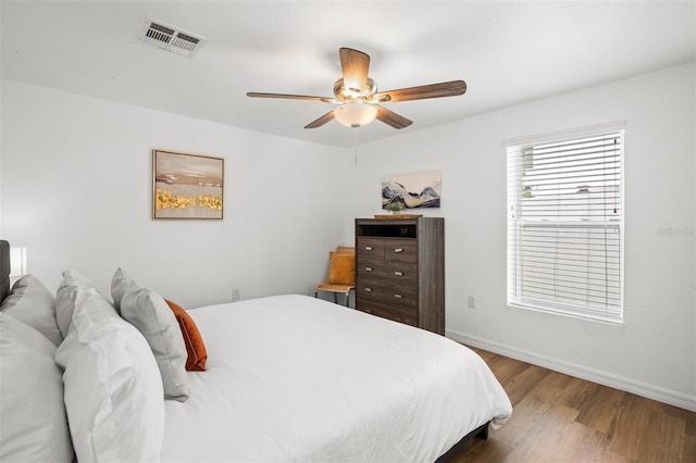 bedroom with ceiling fan and wood-type flooring